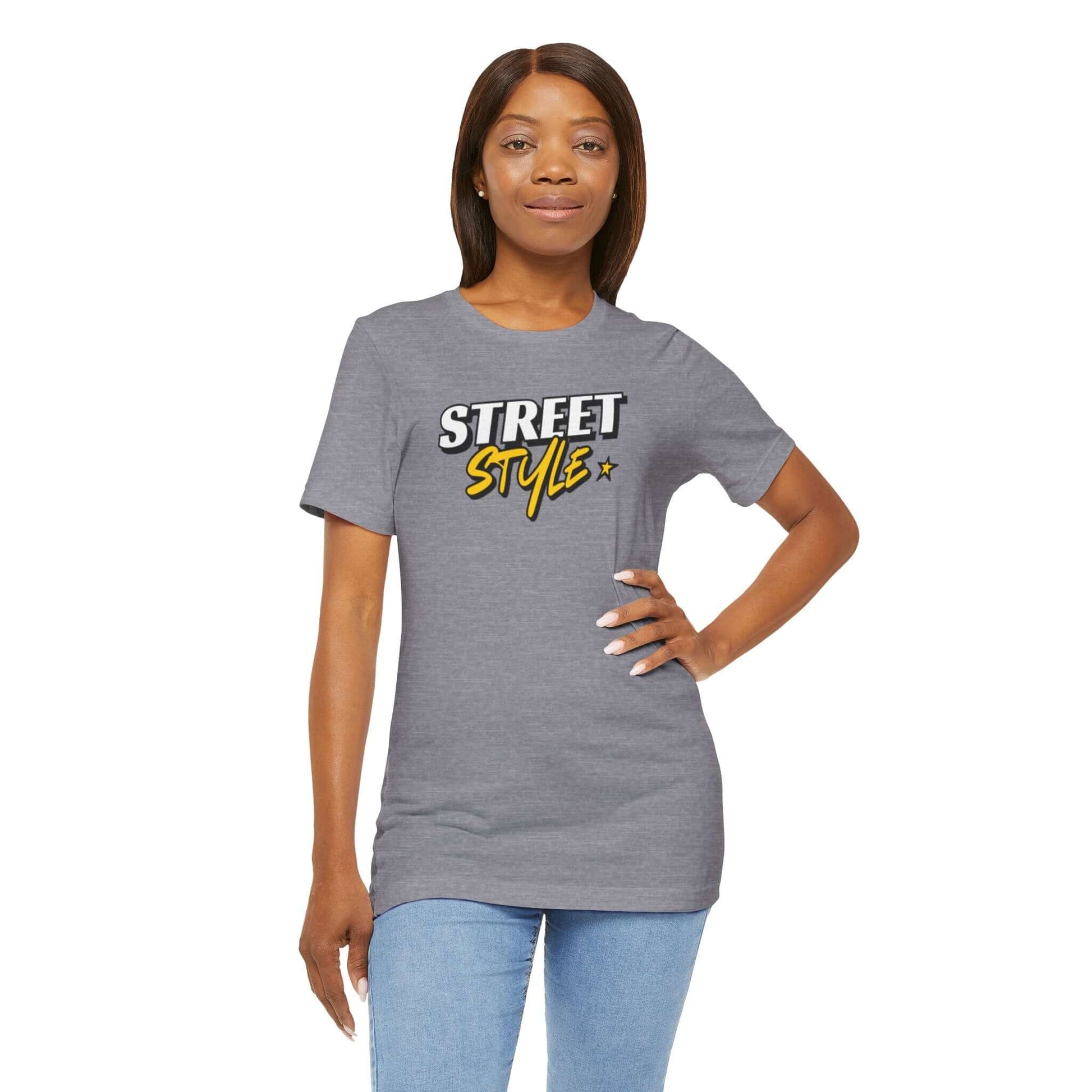 Woman wearing a grey graphic tee with 'STREET STYLE' design, showcasing trendy urban fashion.