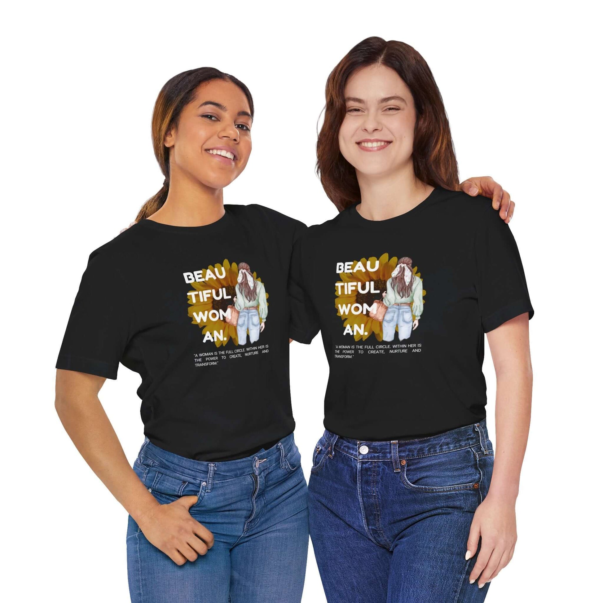 Two women wearing the Empowerment Unisex Tee featuring a graphic design and inspirational message.