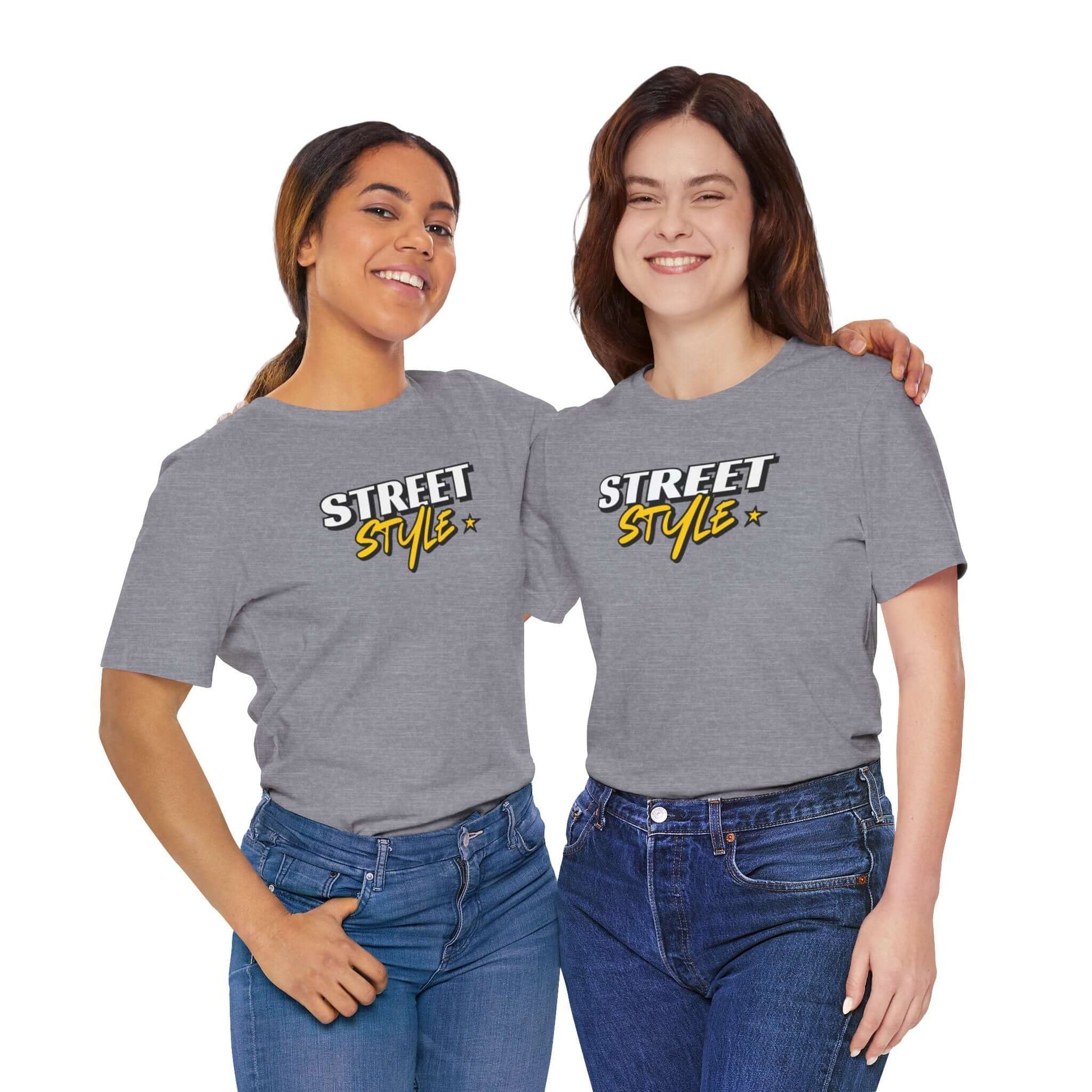 Two women wearing gray graphic tees with 'STREET STYLE' text, showcasing trendy urban fashion.