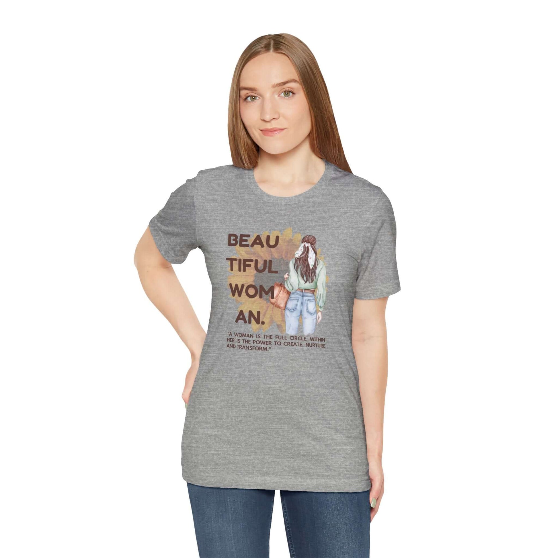 Woman wearing a gray Positive Vibe tee, featuring inspirational graphics about beauty and positivity.