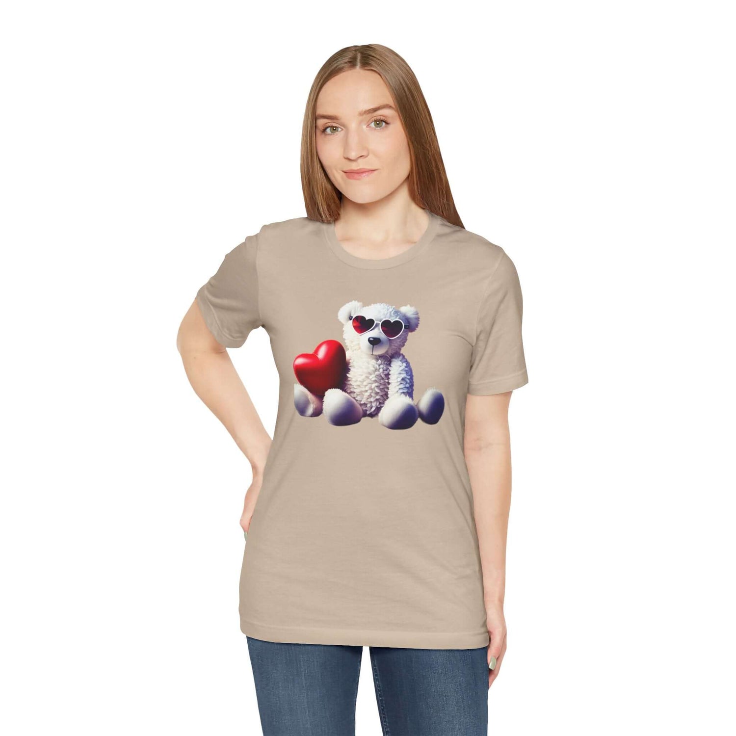 Woman wearing a beige graphic T-shirt featuring a cute bear with heart-shaped sunglasses and a red heart.