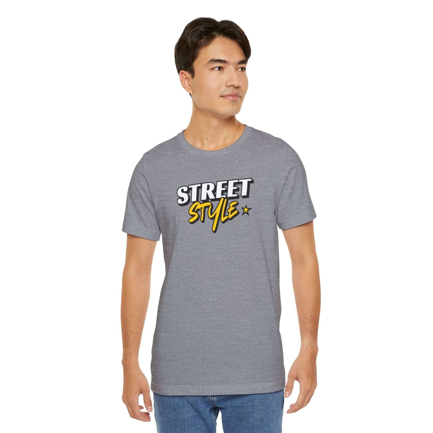 Model wearing a gray graphic tee featuring 'STREET STYLE' design, ideal for urban fashion and casual outfits.