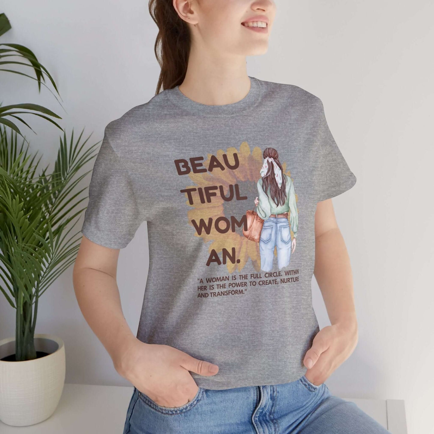 Woman wearing a positive vibe graphic tee with inspirational text, perfect for casual wear.