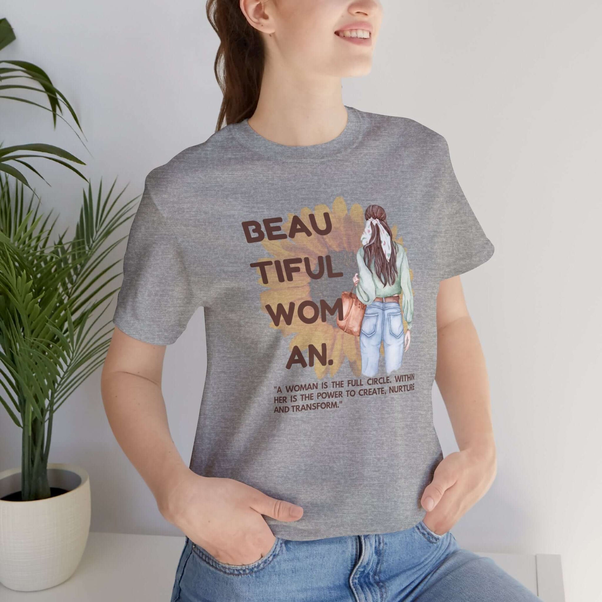 Woman wearing a positive vibe graphic tee with inspirational text, perfect for casual wear.