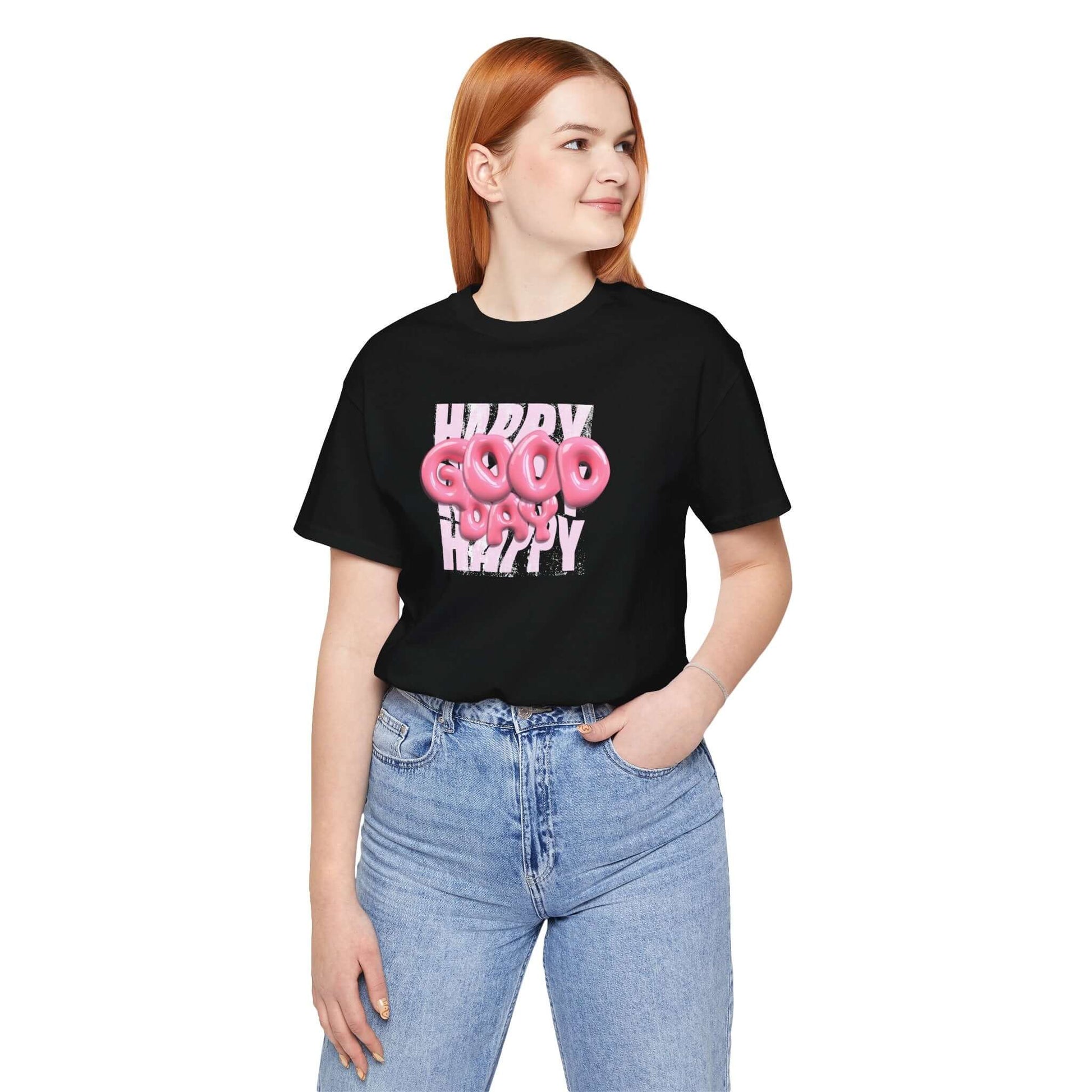 Woman wearing a black graphic tee with 'Happy Good' playful design, perfect for casual wear and fun occasions.
